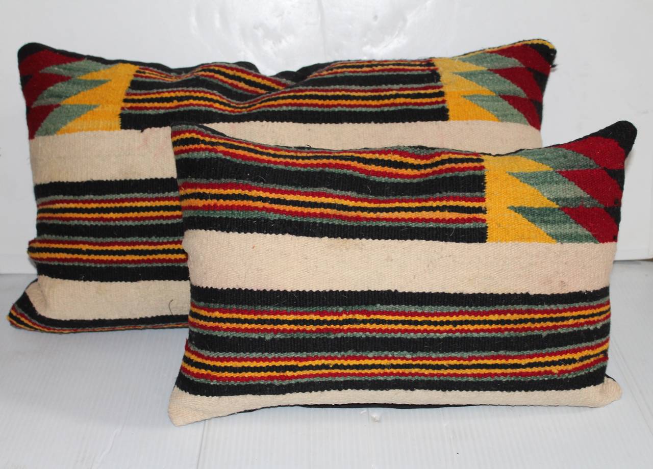 These pillows are cut from the same weaving. They are two different sizes yet go well together. The backing is a black cotton linen. Down and feather fill.