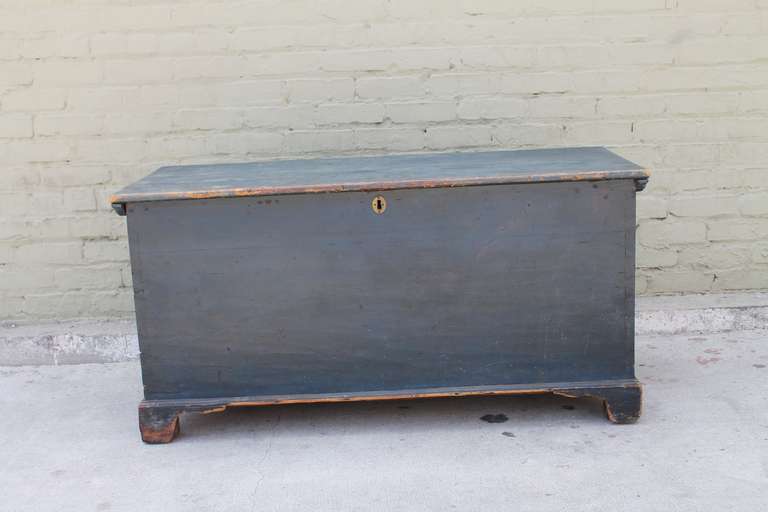 This original cornflower blue painted blanket chest dates to the mid-1800's New England and is in outstanding untouched condition.  This piece shows a lift top with ogee bracket feet and all original hardware with dovetail and square nail