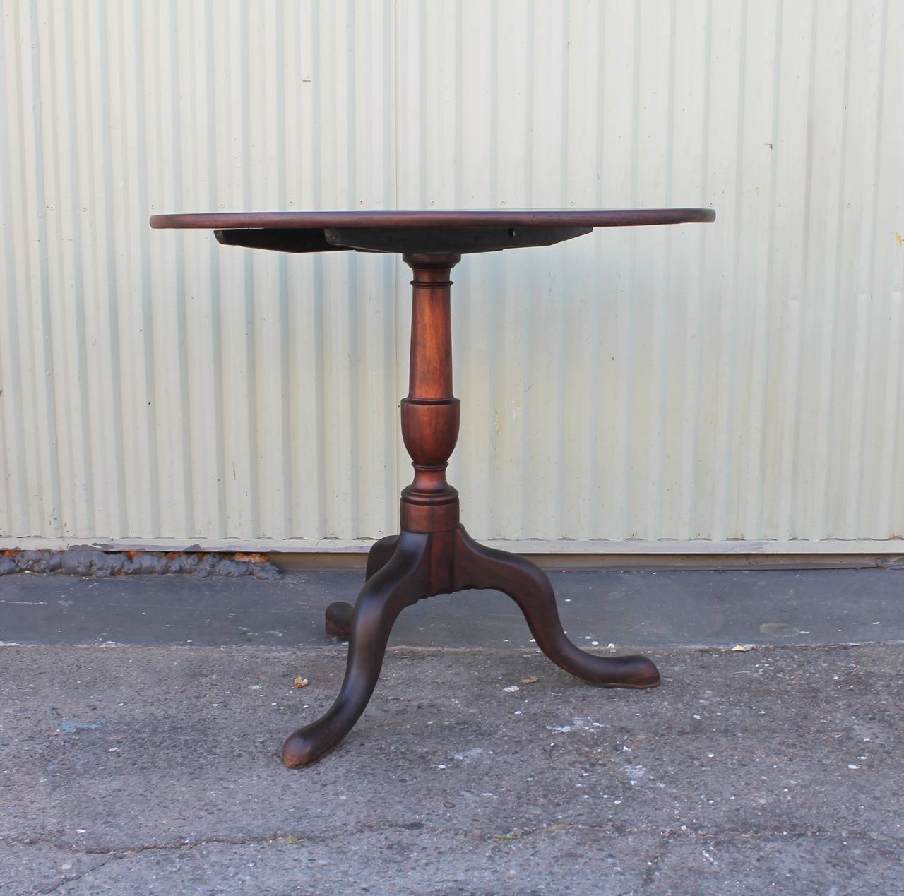 Early 18th century New England Queen Anne stationary lift top table. This table is walnut table has wonderful hand-carved snake legs and was made to be stationary for more sturdy support. The underside of this table has an old worn patina. Of course