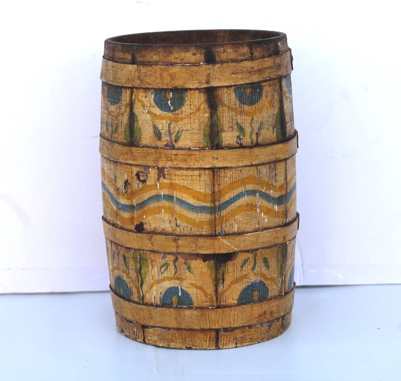 This fun small-scale barrel is in great as found condition and was found in New England. The lid is missing as it was probably a cardboard or heavy paper seal. The back round mustard painted surface is the best patina. it has metal bands that are