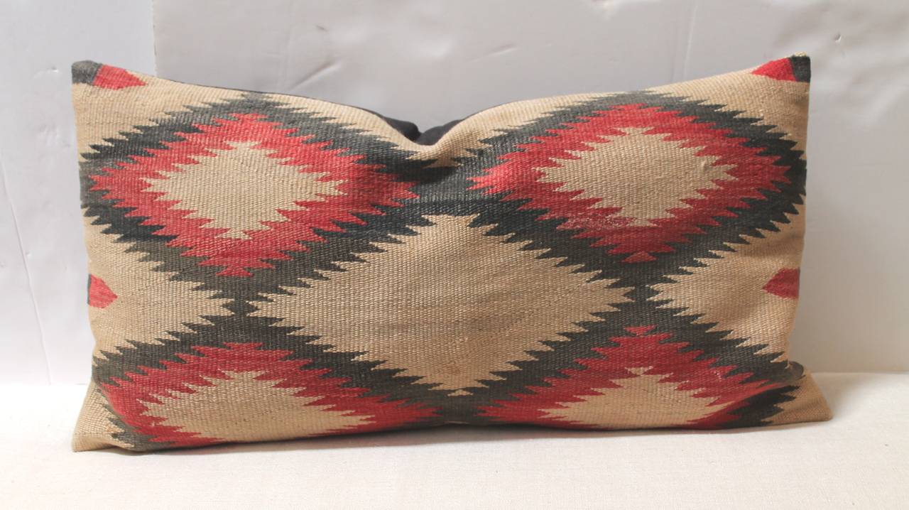 Large Navajo Indian Weaving eye dazzler,  muted colors bolster pillow . The backing is in black cotton linen. These have a soft faded look but are in great as found condition.