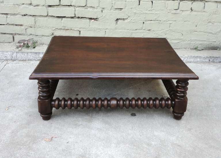 This wonderful handmade spindle table has a great dark natural surface and wonderful spindle stretcher's and legs .This is in sturdy as found condition.This works as a gaming or coffee table .Great in any setting.