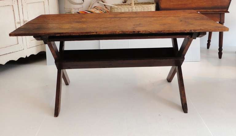 This early 19thc three board scrub top sawbuck table is in wonderful as found condition.The top has a wonderful worn patina and the height is great along with condition being very good.This rustic table would fit in with Americana or folk art