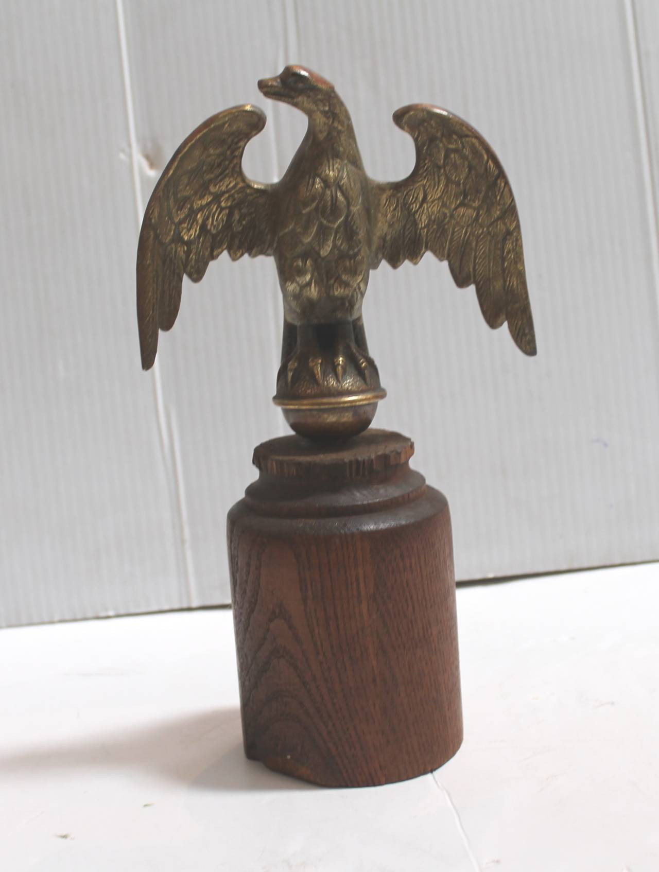 This is a wonderful worn and aged brass eagle from what looks like it sat on top of a flag post. It has a wonderful old surface with minor consistent from age and use. This was found in Pennsylvania. This is a very heavy and solid brass eagle.
