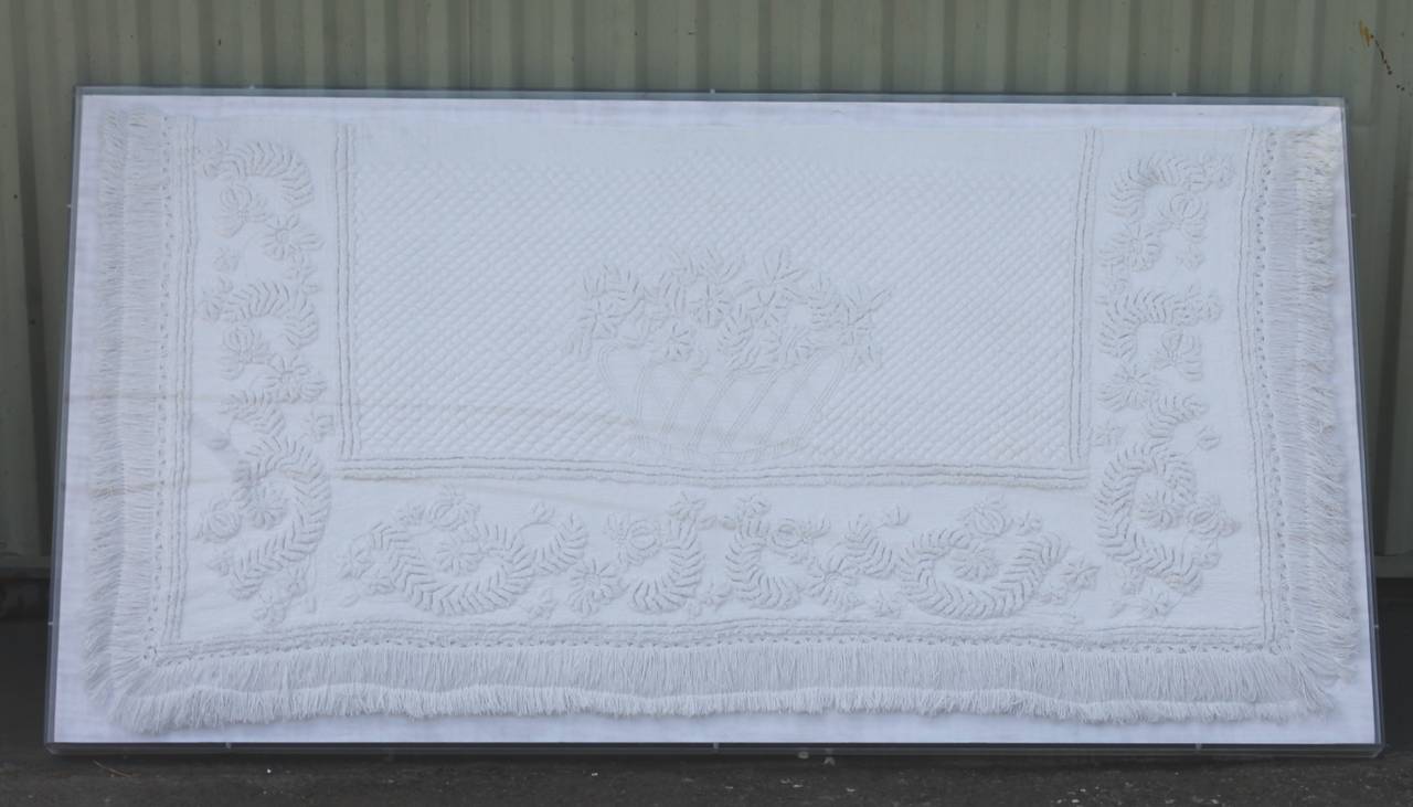 This amazing all handmade and hand quilted early 19th century trapunto sham with a wonderful interesting swag inner border. The hand tied fringe border is also in great as found condition. This sham is professionally mounted and sewn on homespun