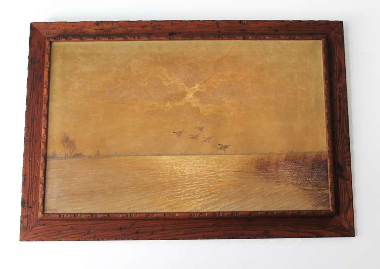 This original rustic wood framed oil painting is a lovely and serene composition featuring five ducks in outbound flight from reeded marsh wetlands. Illuminated by a cloud obscured sun, diffused light creates an atmospherically placid sky. To the