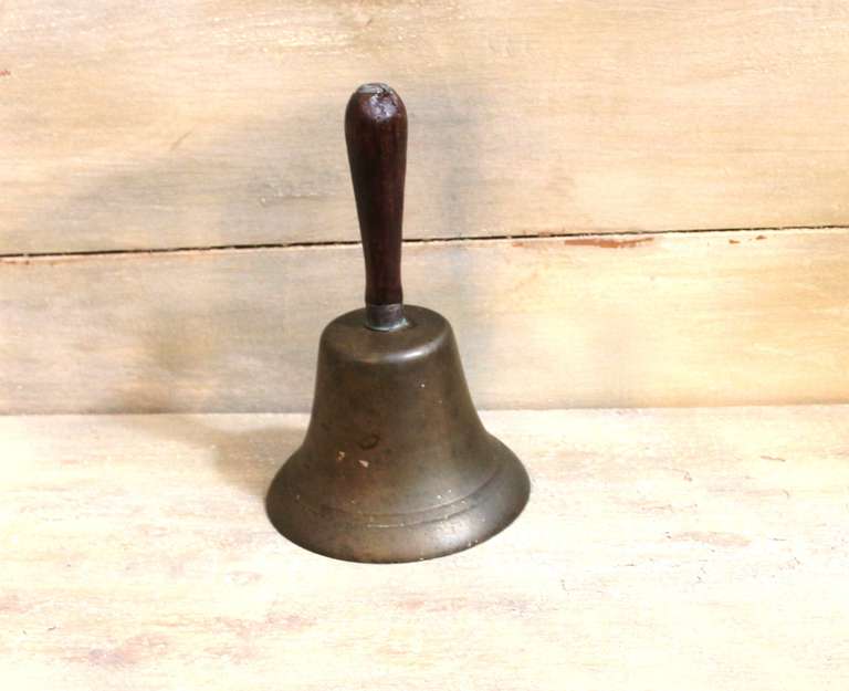Diese Messingglocke aus dem 19. Jahrhundert wurde einst benutzt, um Schüler zum Unterricht oder Familien und Arbeiter zum Essen zu rufen. Aufgrund der substanziellen Dichte der Glocke in Verbindung mit dem originalen Eisenklöppel erzeugt diese