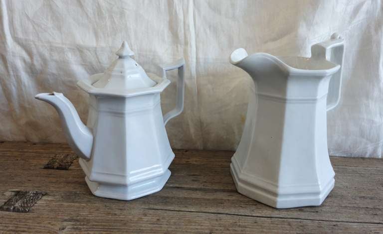 This stunning set consists of a teapot with decorative top and finial and similarly styled pitcher. These English serving pieces are both fashioned in an octagon shape and are in pristine condition with no cracks or chips.