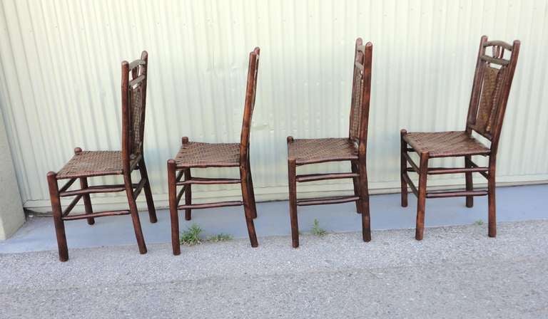 Fantastic set of four matching signed Old Hickory Furniture , Martinsville , Indiana . These  sturdy and folky form chairs are from the 1930's and are very comfortable .Each chair has the burned in makers name on the lower rear leg.This unusual form
