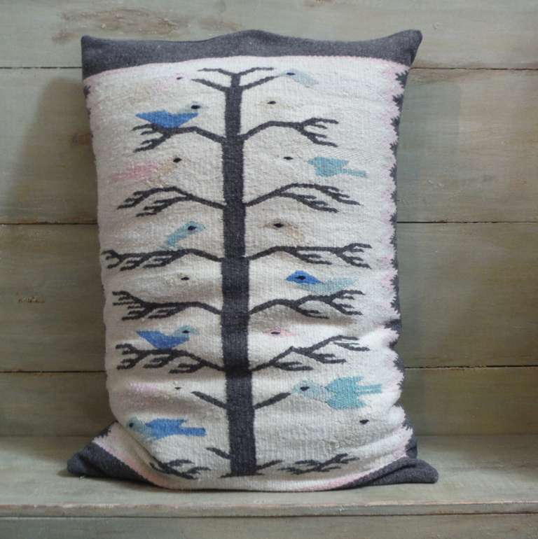 This pillow was constructed from a Navajo Tree of Life weaving from the Cedar Ridge area in the northern part of the Navajo Nation and dates to the 1940s. Pictured in this weaving are a classic array of pastel colored birds perched on and around the