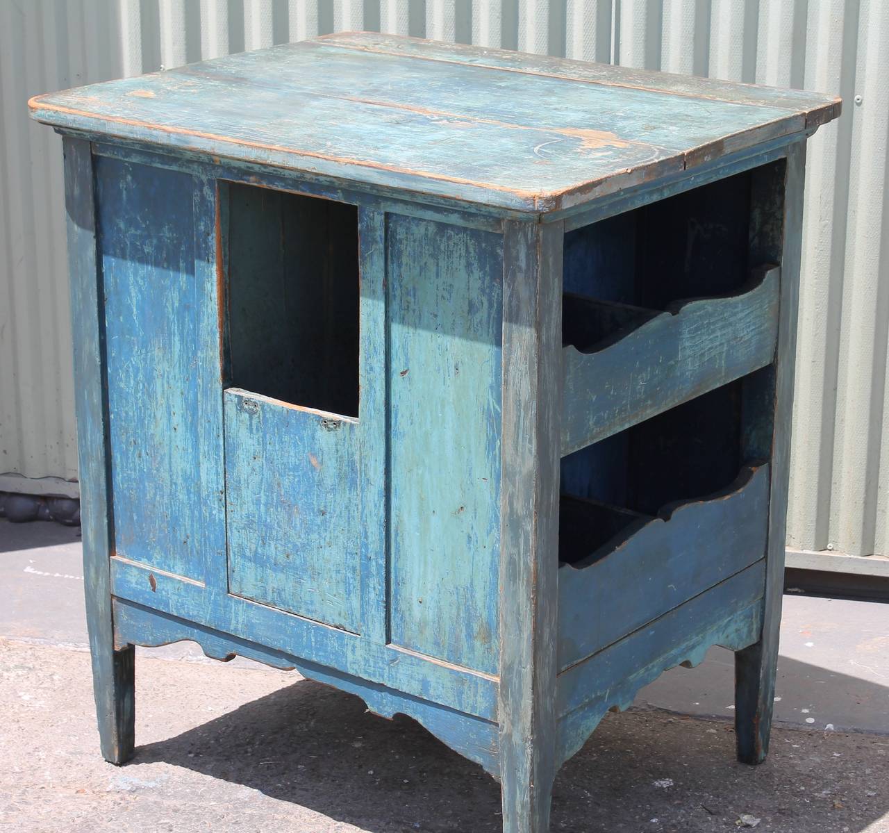 This multi functional table has many different compartments and shelving built with in the cabinet. Makes a great side or end table. The condition is good with wear consistent from age and use. This 19thc cabinet is in a original blue painted