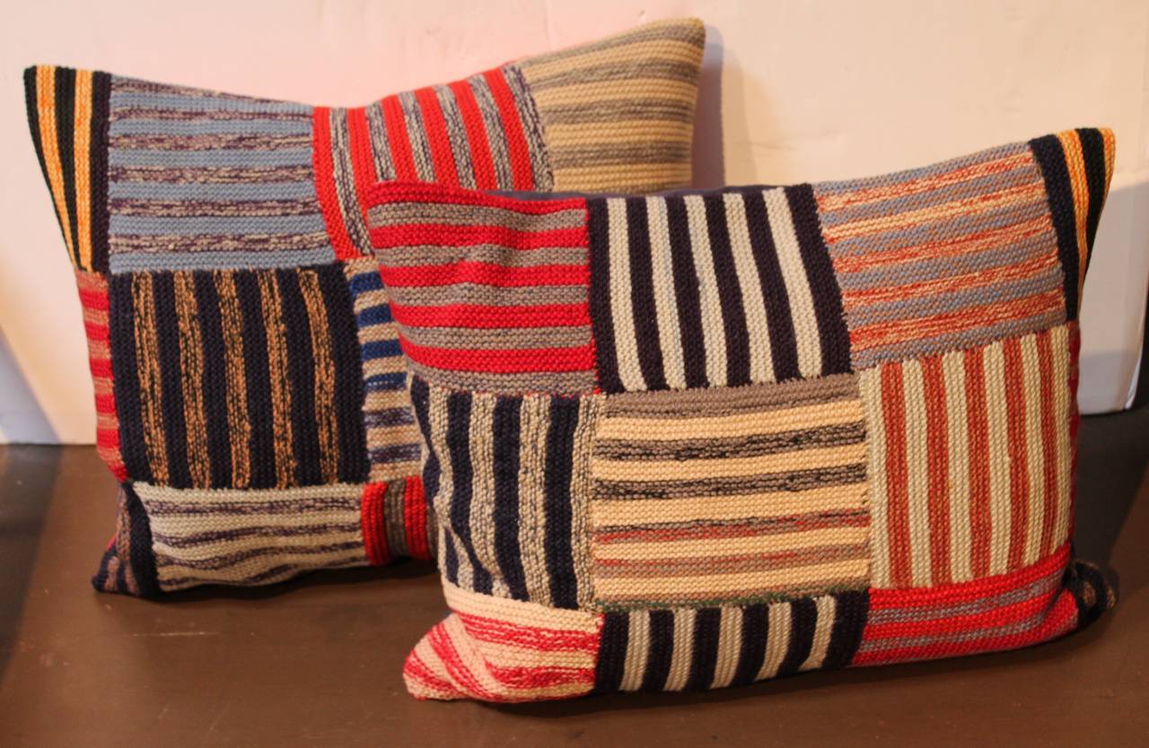 These amazing hand knit yarn pillows are in great condition and have been cut from an old vintage throw. The backing is in a red cotton linen and a blue cotton linen. Sold as a pair.