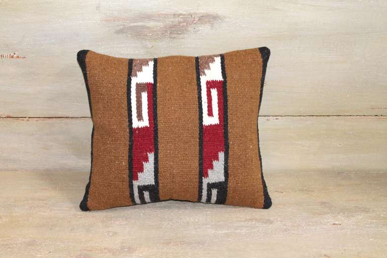 This graphically strong Navajo woven pillow was constructed from a crystal saddle blanket showing step and 