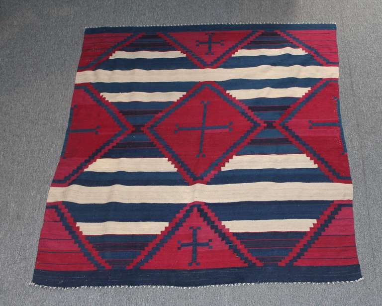 This Navajo Chiefs Rug is similar in design and construction to a Chiefs Blanket but is an older replication utilizing heavy yarns in cream, dark indigo and maroon.  Rugs of this nature are in a category of their own that were sold at trading posts