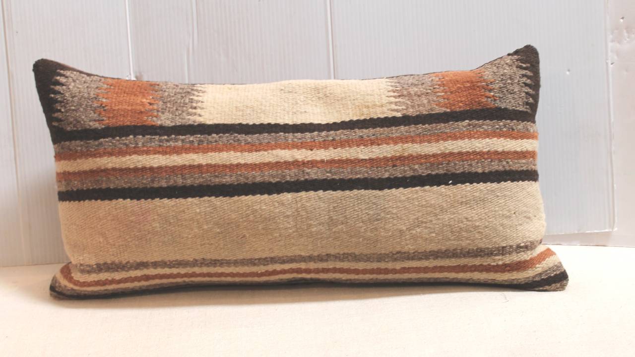 This handsome pair of Navajo Indian weaving saddle blanket pillows are in great condition and have brown cotton linen backing. The inserts are down and feather fill.Sold as a pair only.