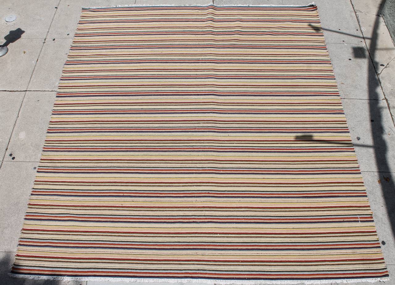 Early wool rag rug with a small fringe at each end of the rug. This rug is in great as found condition and recently prof. cleaned. It is 99