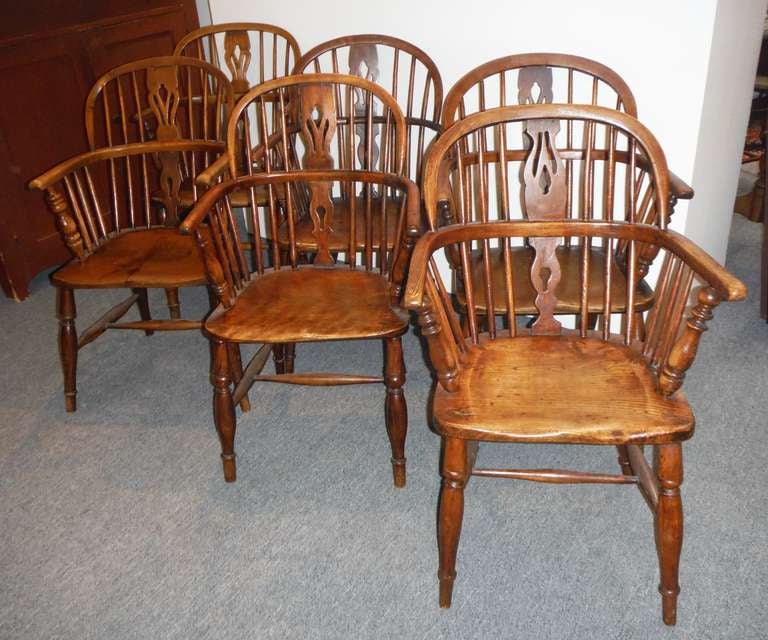Set of six matching early 19thc English Windsor Chairs.These beautiful extended arm bow back Windsors are in wonderful condition and very comfortable . The chairs are made from ash and walnut woods.The worn patina on the seats and arms show their