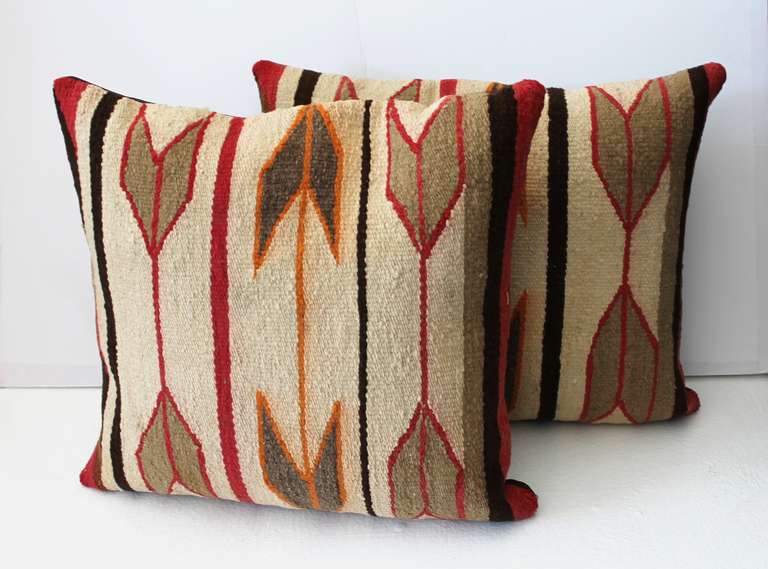 This striking pair of pillows were made from a Navajo Indian Crystal weaving showing a colorfully outlined arrow pattern against an ivory background.  Woven from hand carded Churro wool, the weaving from which these pillows were constructed are from