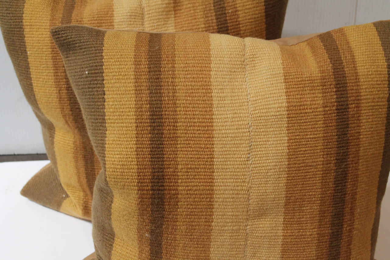 This amazing hand woven rag rug pillows are in tan and gold colors and great condition. The backing is in tan cotton linen.