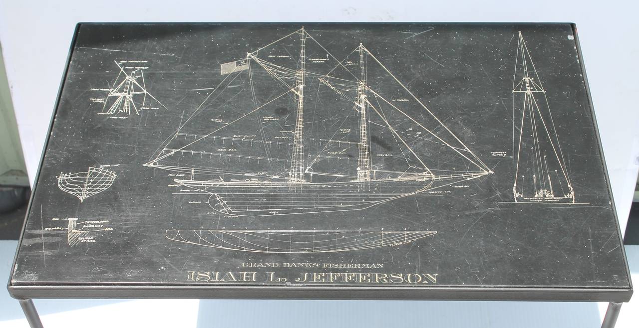 This folky nautical drawing of the Grand Banks Fisherman looks like a blueprint. It is all hand-carved on a heavy piece or slab of slate with a polished top. The condition is very good with minor scratches or chips on the edges consistent from age