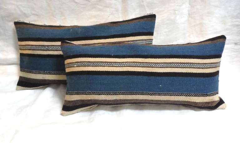 These rich ,yet simple hand woven wool Indian weaving kidney pillows.These stripped Tex Coco pillows have linen backing and down & feather fill are sold as a pair .