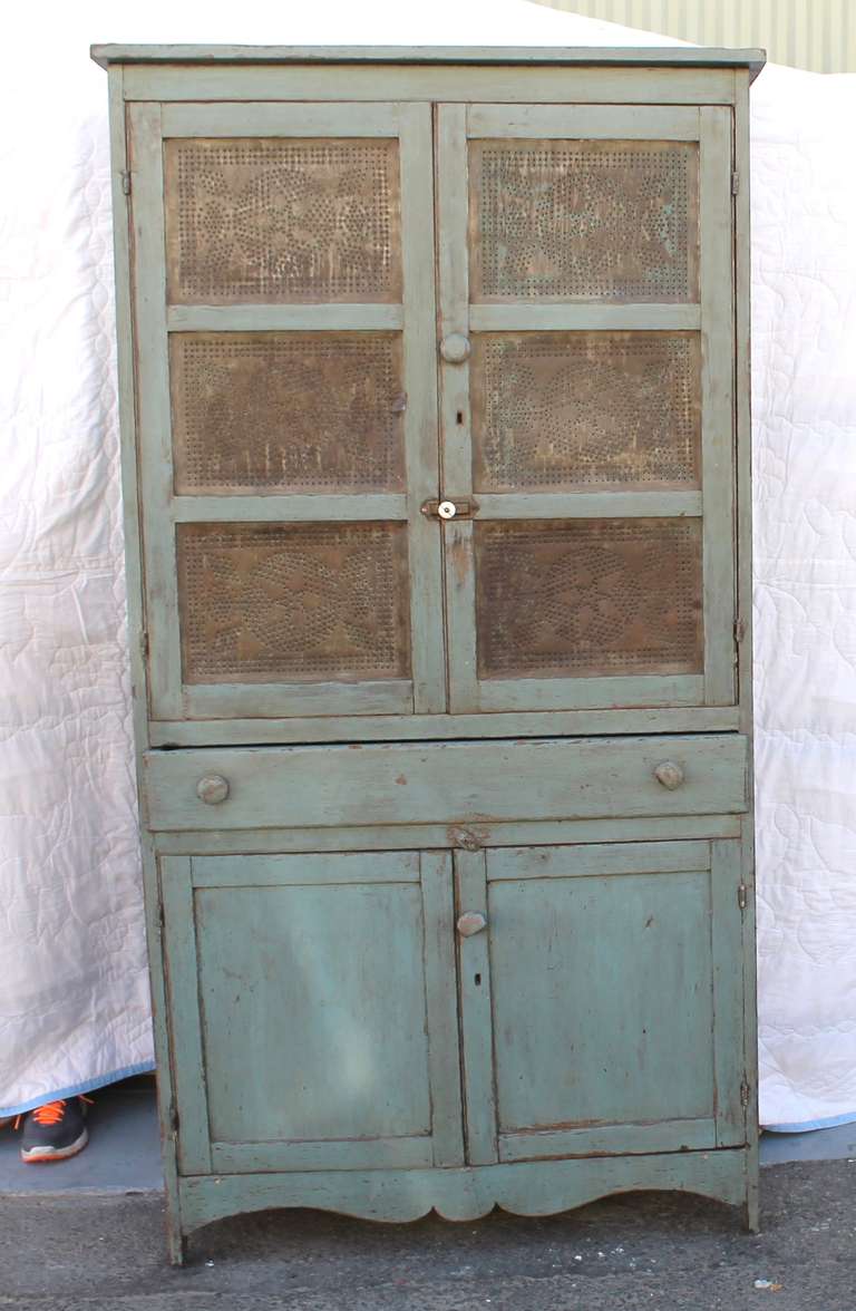 This 19th century original blue painted Pie Safe is from Lancaster County Pennsylvania and shows exceptional character with a rich patina.  Blue paint and an interior white washed finish were added at the turn of then century.  Six wood framed