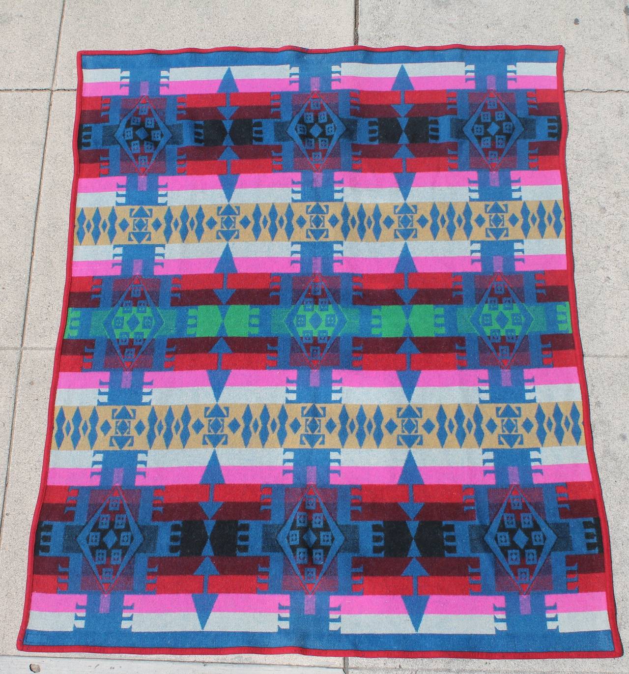 Fantastic early 20Thc Pendleton  Cayuse Indian design camp blanket with the original fabric label. The condition is very good. This blanket is in the most unusual colors and quite geometric pattern. This blanket has the original red welting or