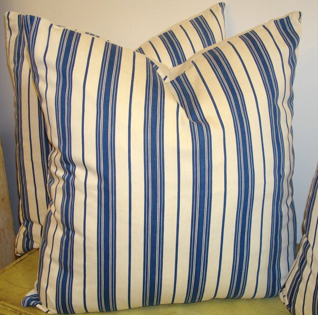 19THC BLUE & WHITE TICKING PILLOWS W/ WHITE HOMESPUN LINEN BACKING.DOWN & FEATHER FILL.SOLD INDIVIDUALY AT 395. EACH/ SIX IN STOCK.