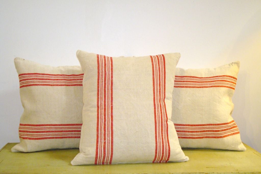 19THC STRIPED LINEN FEED SACK PILLOWS.STRIPED ON FRONT AND BACK.DOWN AND FEATHER FILL.SOLD INDIVIDUALY AT 250. EACH, TOTAL OF FOUR IN STOCK.