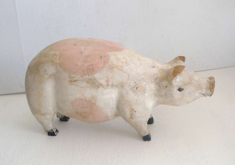 Wow what a pig ! This big pig has the best surface and very well loved . She has glass eyes and wonderful original paint .There is minor wear on the ears and the nose .The feet and entire body is carved out of one piece of wood.The pigs tail is also