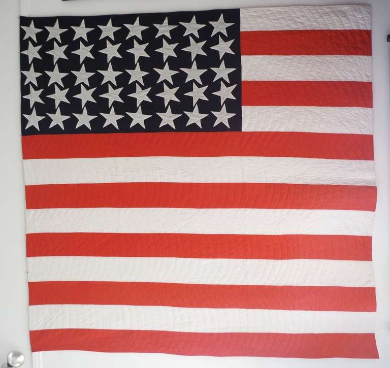 This star spangled banner quilt is a hand stitched replica of a 48 star United States flag from the World War I era.   Outline quilting, done completely by hand

A beautiful rendition of Old Glory, this quilt shows its age with a very slight fade