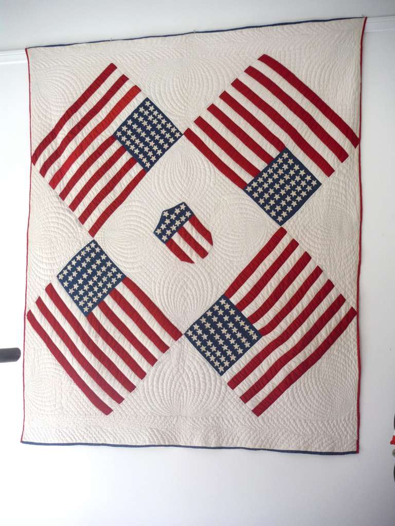This most unusual patriotic floating flags quilt has amazing quilting and piece work. All stars are hand-stitched and appliqued. The stripes in the flags are all hand pieced. The condition is the very best and has been professionally laundered. The