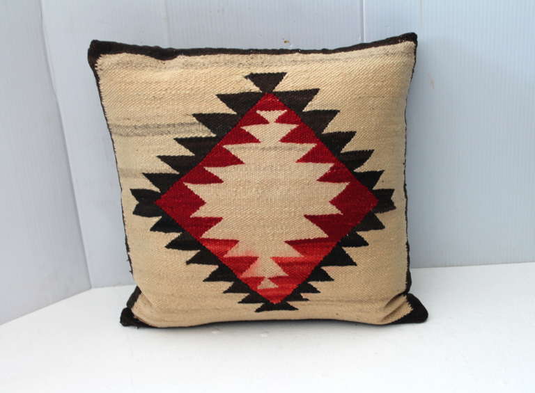 This three colored weaving has a great sord of aged patina in the flax of the wool. The sawtooth pattern that is a out side looking in pattern. This is a early example of a Ganado sampler. The condition is good with minor bleeding in base of the red