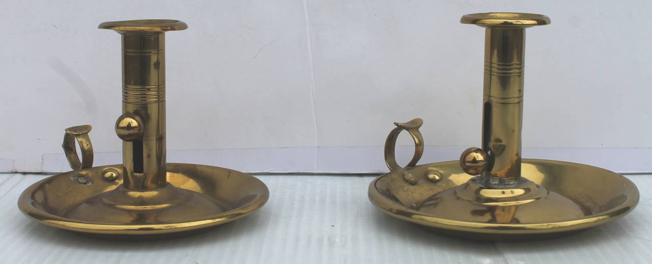 This pair of fantastic 19th century New England brass candleholders are in great as found condition and were found in New England. This is a mismatch pair as one is a little larger then the other. The underside is iron as in the guts too. The entire