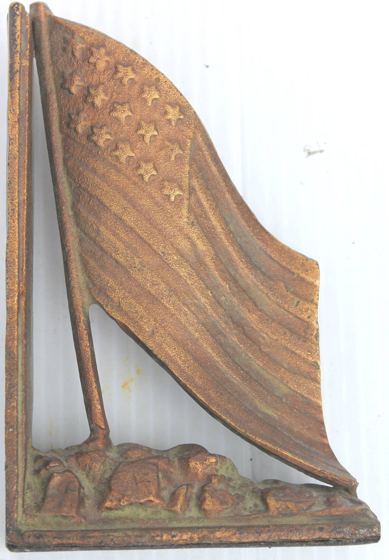 Early 20th c American Flag doorstop with a wonderful gilded surface over brass. The condition is very good.
