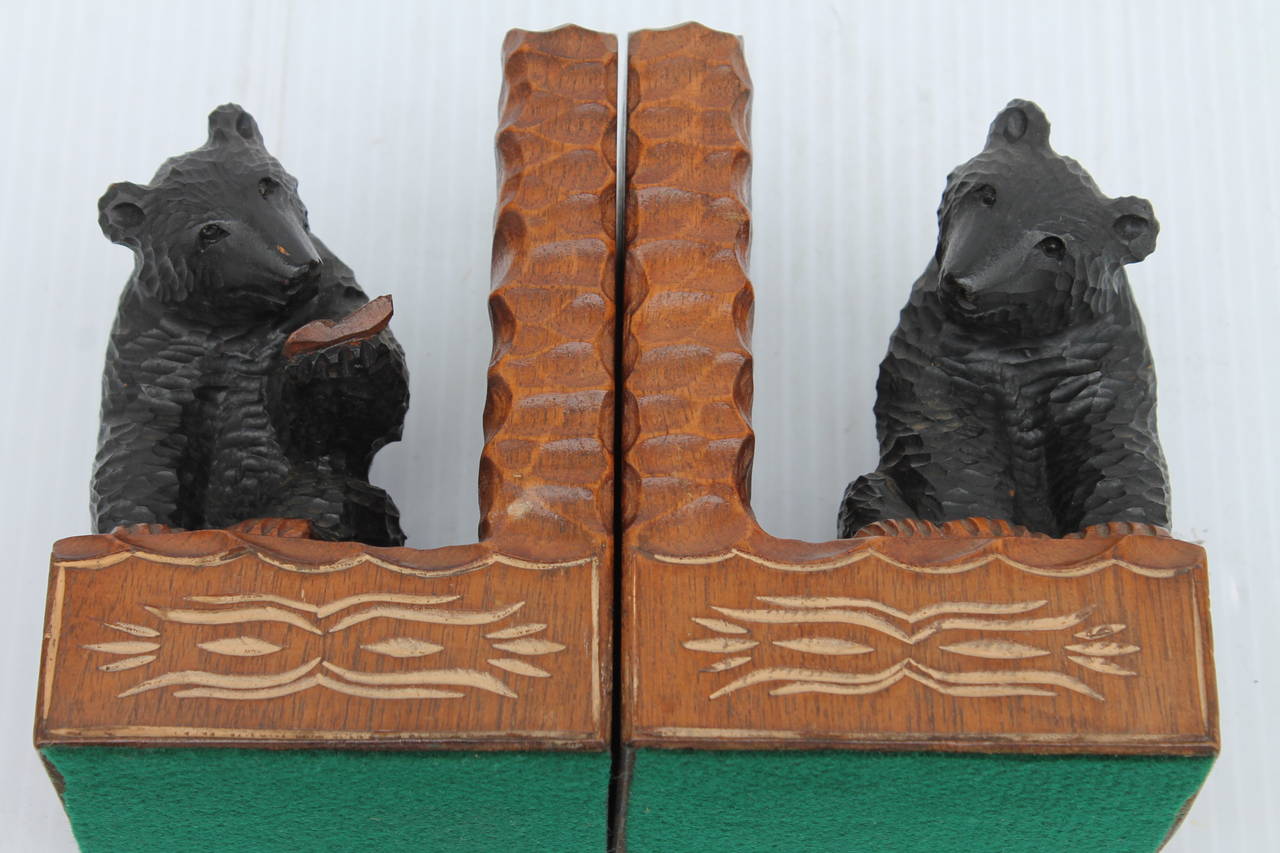 This fine pair of hand-carved and original painted wood bear bookends are in great condition. One bear is reading a book! Found in the Midwest.