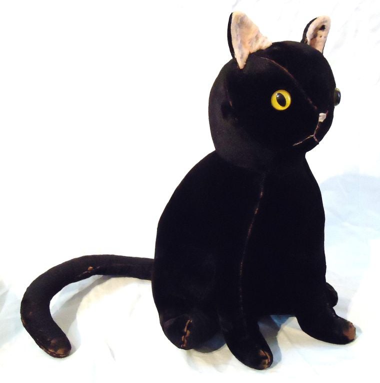 THIS FANTASTIC ,FOLKY,FUN BLACK CAT HAS ARRIVED JUST BEFORE HALLOWEEN.IT IS THE COOLEST CAT EVER.IT IS WOOL STUFFED AND COVERED IN BLACK VEVET WITH LARGE YELLOW AND BLACK EYES.THE EARS ARE BLACK ON THE OUTSIDE AND FLESH  COLORED ON THE INTERIOR,IT