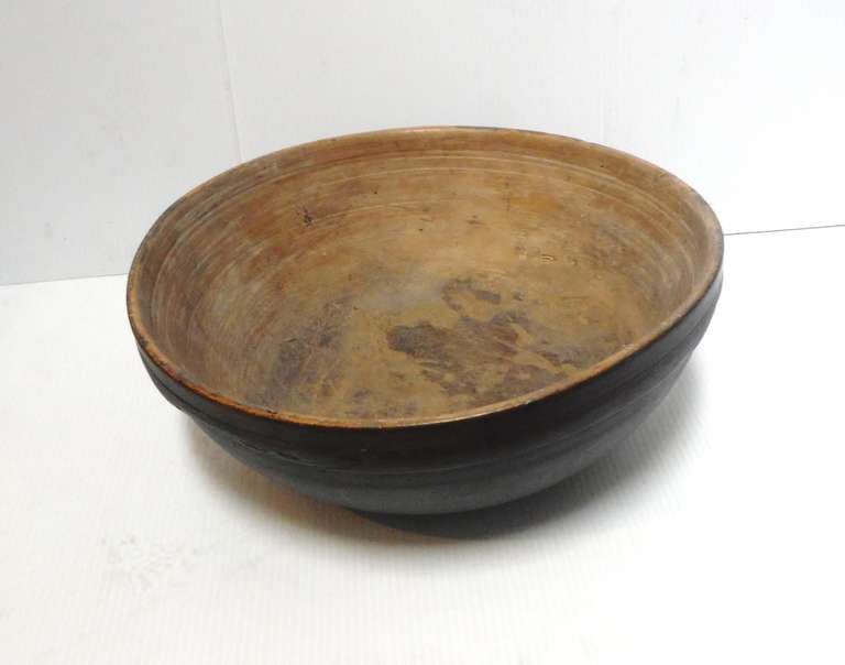 18THC Original painted and hand carved dough bowl with the early hand made masher .The painted surface is a brown /green painted exterior and a slight white washed painted interior. The condition is very good with no splits  or cracks. The patina is