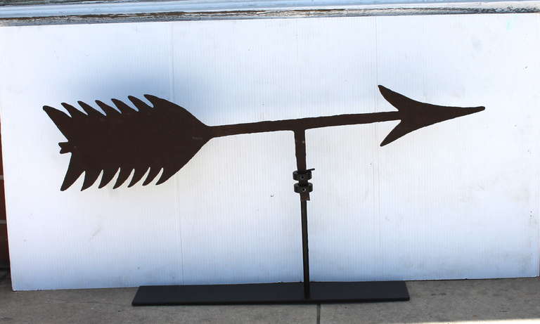 This very heavy hand made iron 19thc arrow weather vane was found in Vermont and most likely from the roof top of a large barn or church. This early vane has a wonderful worn, aged patina with no bullet holes or cracks. The folky cut out feathers