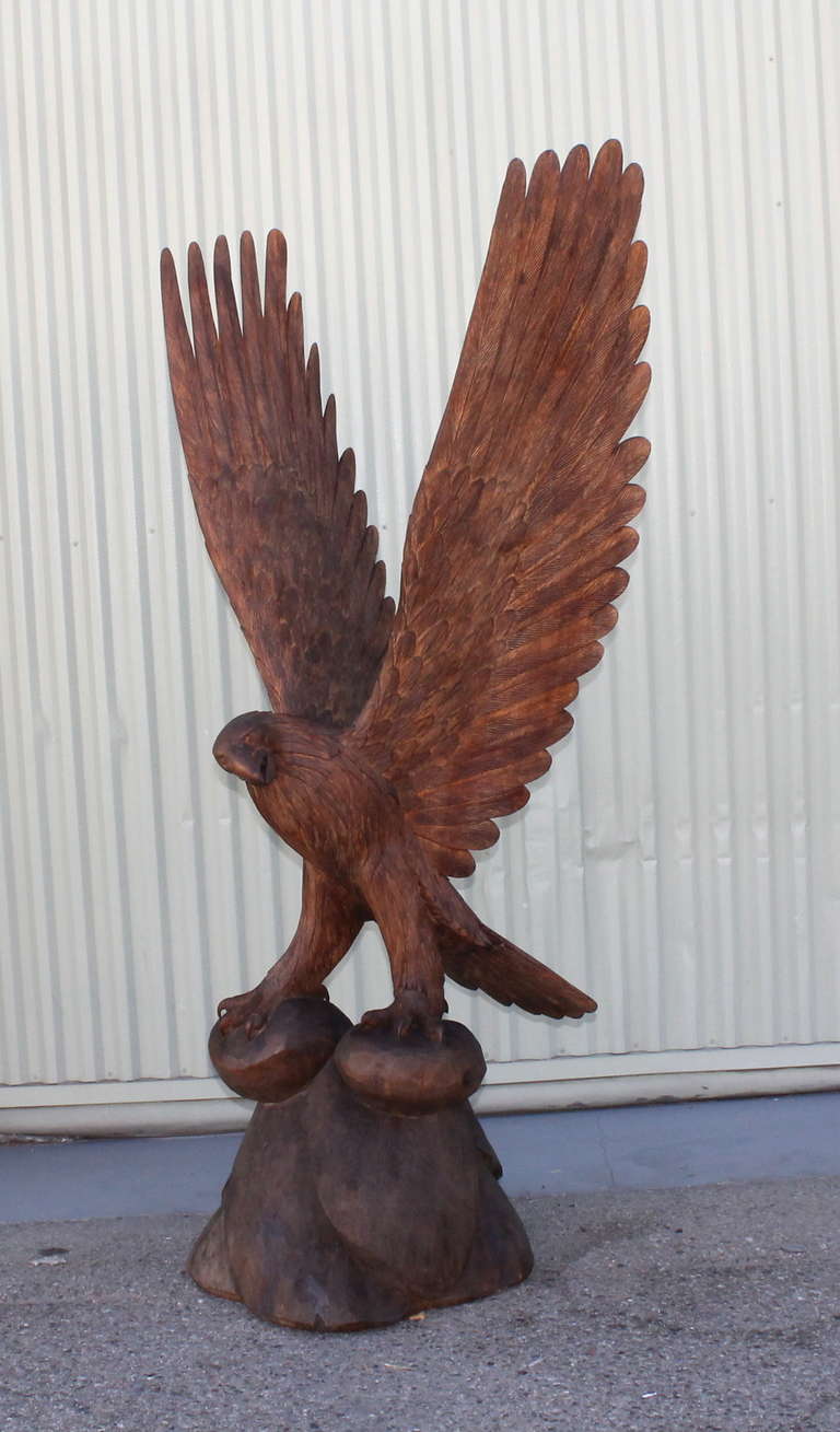 Fantastic large hand carved eagle from Arizona on large wood base. This unbelievable sculpture is unsigned and has a great patina and presence. The wing span is 36 inches wide with great detail given to the carving of the feathers. The weight is