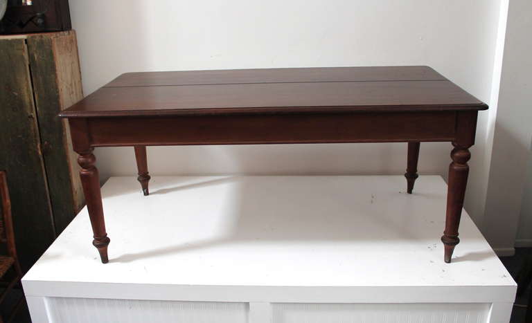 This early hand made walnut table was found in Pennsylvania and has a wonderful simple form yet amazing hand turned legs. The condition is very good and very strong and sturdy. This large dinning table is from the mid 19th century and has a 