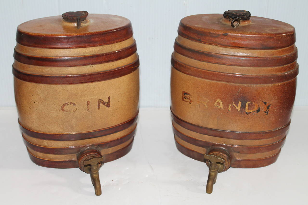 This fine pair of pottery gin and brandy kegs are in wonderful as found condition. The brass spigots and corks are all original. There are no makers marks on this pair and are most unusual.