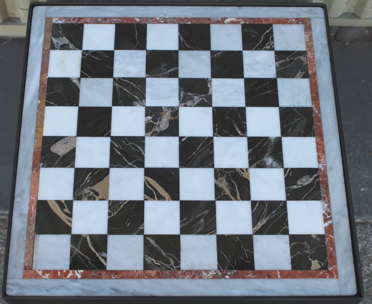 This is a fine example of great quality marble game board laid in a custom-made and forged iron base. This marble board can pop out if need be for cleaning or removing to hand or display. This table is tight and very sturdy. Great in a game room,