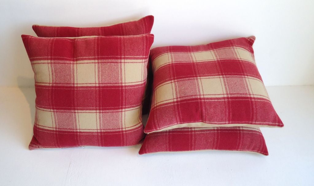 Ealry 20th century wool pendleton blanket pillows n raspberry and cream plaid with cream homespun wool blanket backing. Sold as a pair for 695. Total of four pillows.