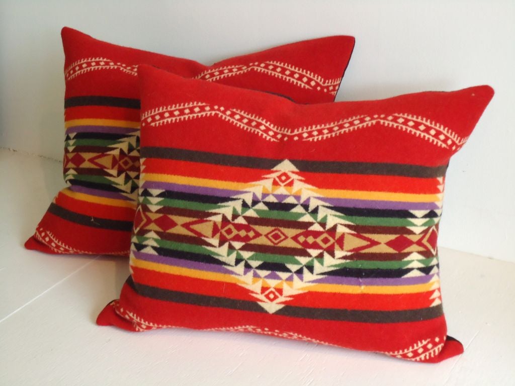 PAIR OF RED BACKROUND WOOL PENDLETON BLANKET PILLOWS W/BLACK LINEN BACKING.SOLD AS A PAIR FOR 595..DOWN & FEATHER FILL INSERTS.