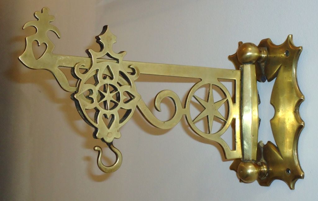 Early 19th century brass wall bracket from New England. This fantastic folky wall hanger could be used to display leather fire buckets or other American objects. This wonderful as found condition and originally it comes from the state of Maine.