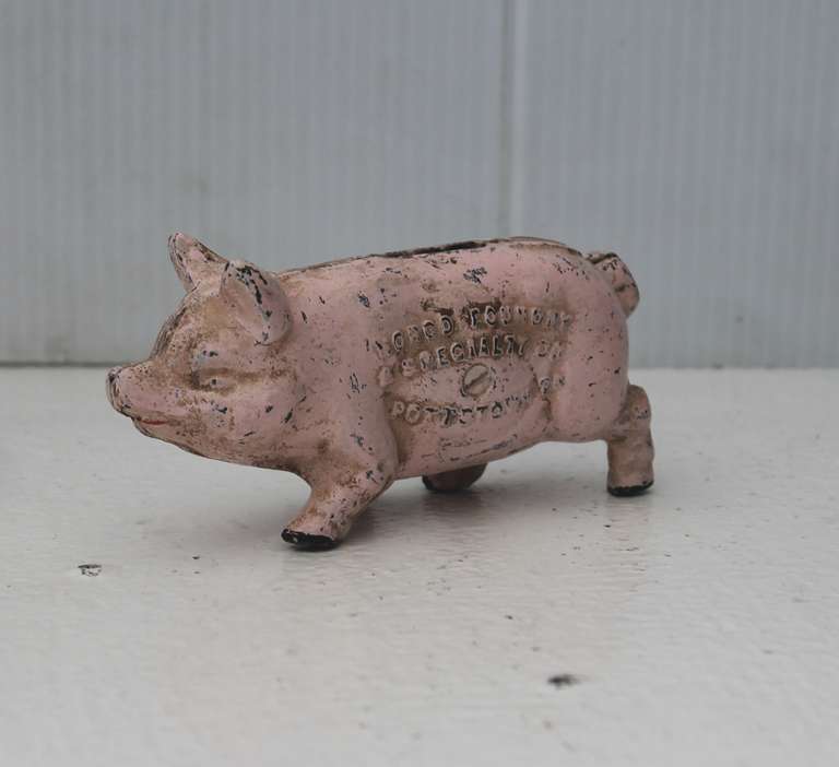 Early 20th century pink painted piggy bank. Signed Norco  Foundry A Specialty Co. , Pottstown, PA. and on the other side of the belly it reads 