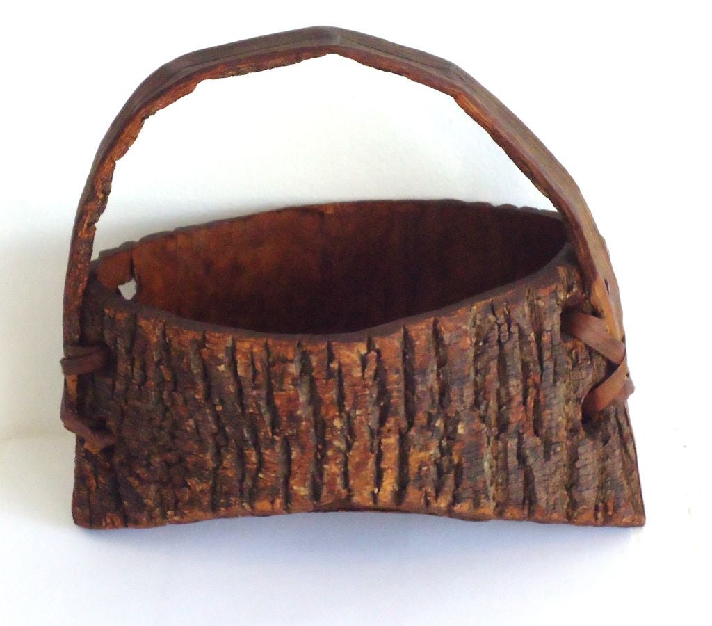 Early 20th century bark covered wall pocket from the state of Maine. This folky handmade handled wall pocket looks like American Indian made but I am not certain. The condition is very good and has a great rustic or cabin look.