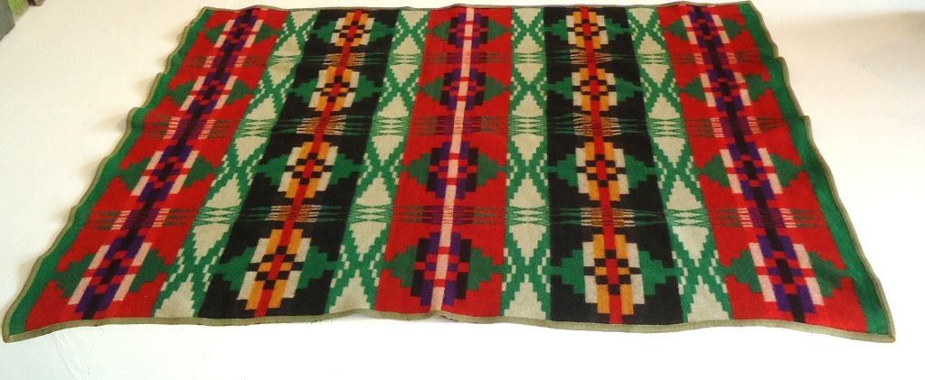 1920'S WOOL PENDLETON BLANKET WITH THE ORIGINAL LABEL .THIS COLORFUL GEOMETRIC BLANKET HAS THE ORIGINAL CAYUSE LABEL AND ORIGINAL BINDING.THE CONDITION IS VERY GOOD.THE COLORS AND DESIGN ARE SPECTACTULAR.THIS IS A VERY HARD TO FIND BLANKET.