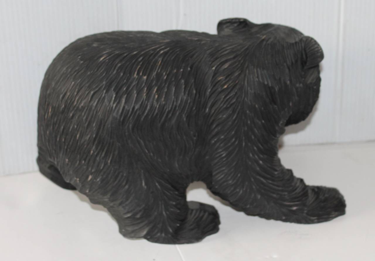 bear with fish in mouth statue
